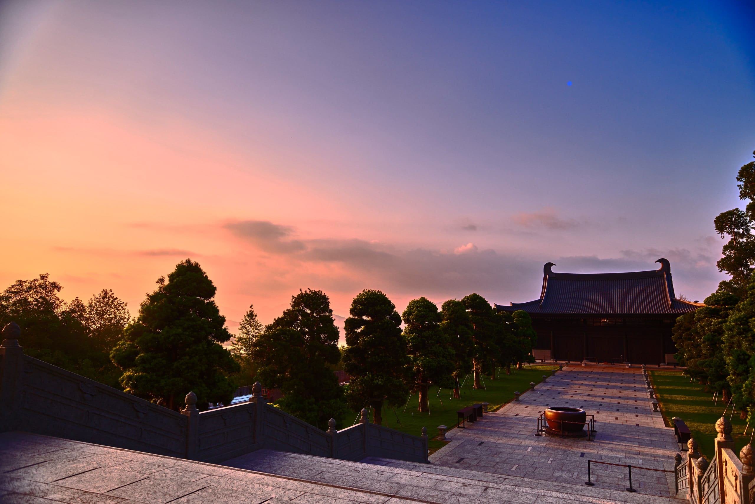 Dusk over the courtyard, hall roof at right.