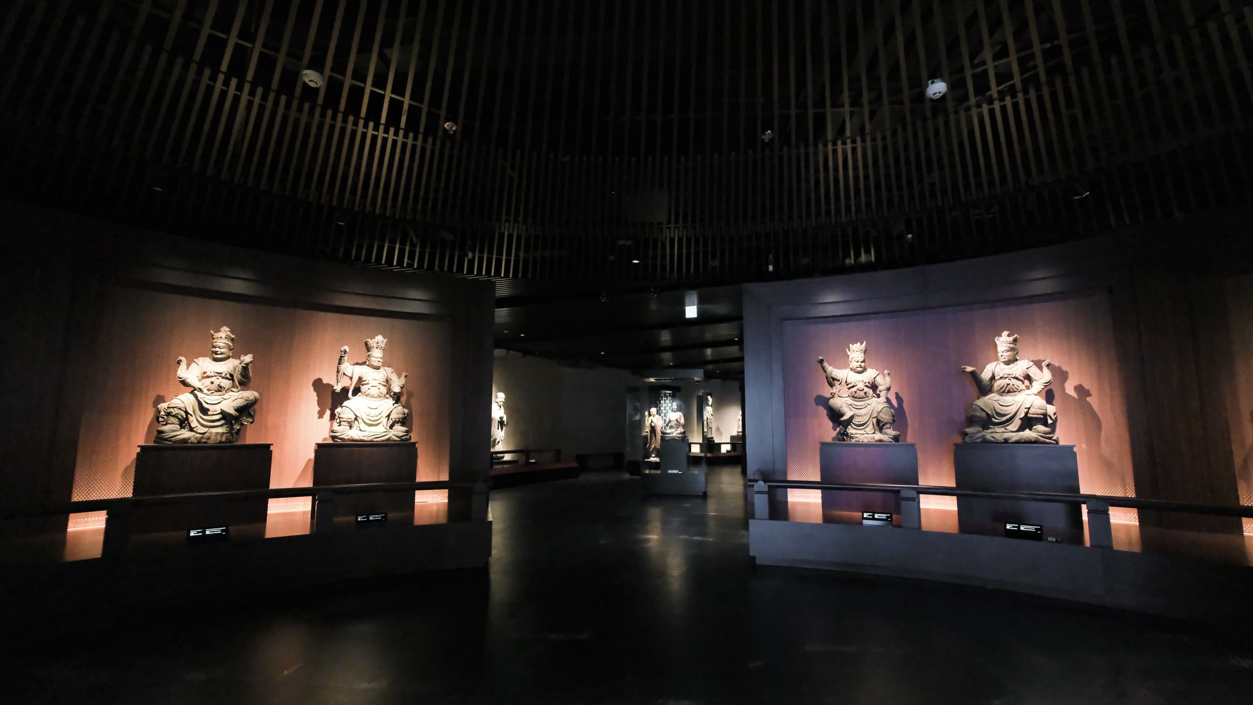 Seated figures in a gallery of the Buddhist Art Museum.