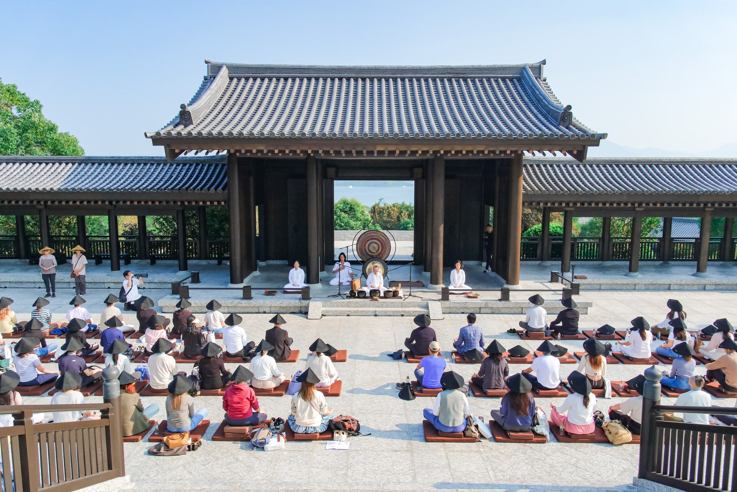 A sound-healing session in the courtyard, a gong beneath the gateway.